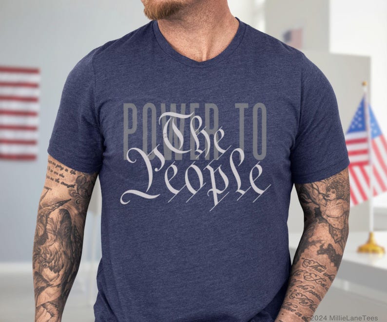 May include: A navy blue t-shirt with a white graphic that says "Power to the People" in a stylized font.