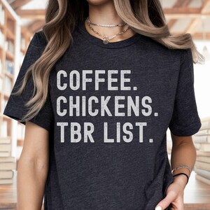 May include: A dark grey t-shirt with the text "COFFEE. CHICKENS. TBR LIST." printed in white.