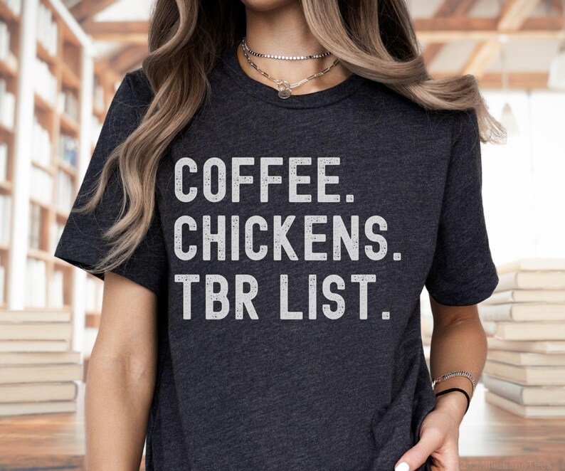 May include: A dark grey t-shirt with the text "COFFEE. CHICKENS. TBR LIST." printed in white.