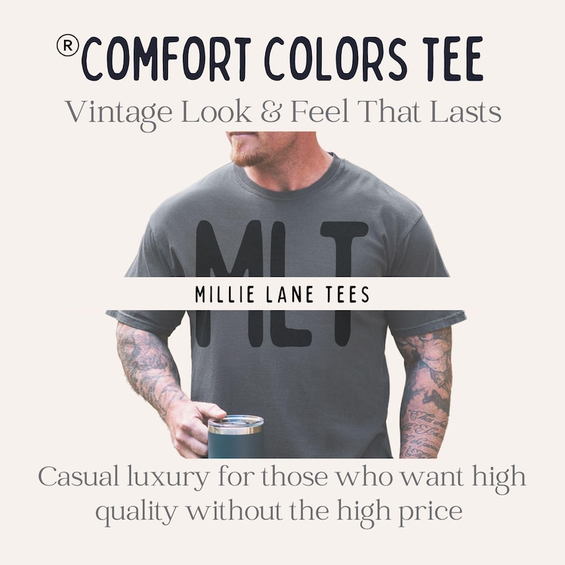 May include: A dark gray short-sleeved t-shirt featuring the text "MLT" and "MILLIE LANE TEES" across the chest. The image includes the text "COMFORT COLORS TEE", "Vintage Look & Feel That Lasts", and "Casual luxury for those who want high quality without the high price".