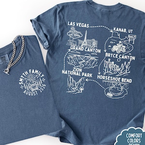 May include: Two denim blue t-shirts. One features a white graphic with the text "SMYTH FAMILY AUGUST 2026". The other has a map design with landmarks like the Grand Canyon and Bryce Canyon. The shirts are available in youth and adult sizes.