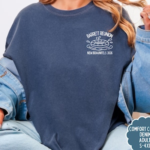 May include: A navy blue sweatshirt with a white graphic of a life preserver and the text "Barrett Reunion New Braunfels 2026". The sweatshirt is part of the Comfort Colors Denim Adult collection and is available in sizes S-4XL.