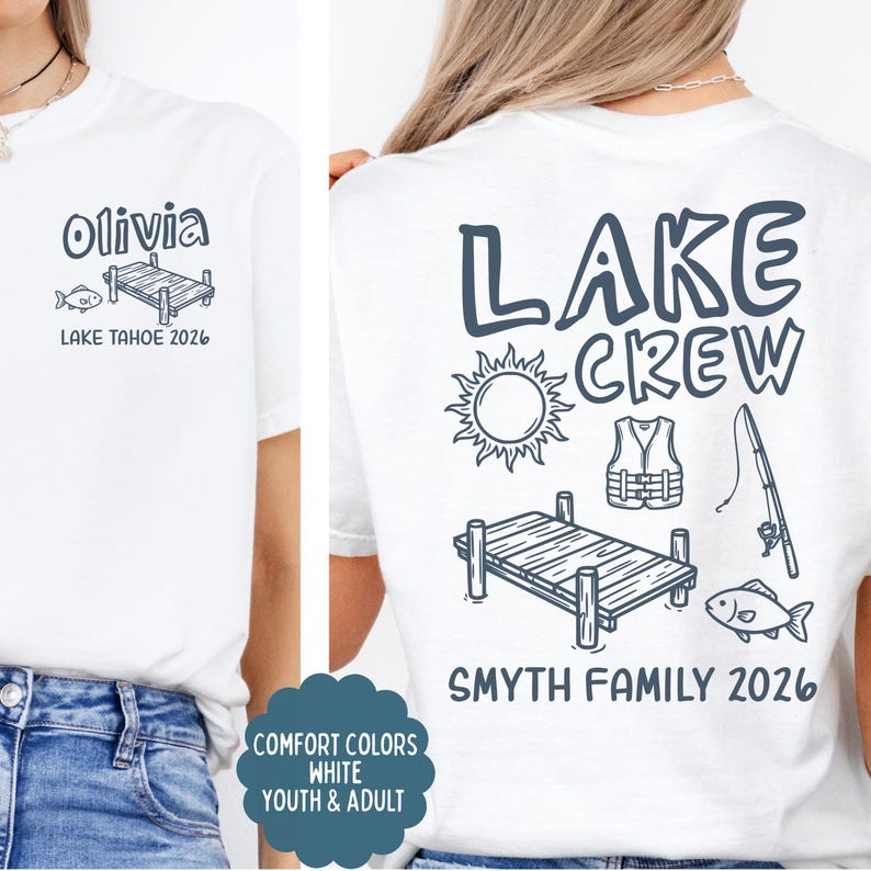 May include: White t-shirt with a lake theme design. The front features the name "Olivia" above a dock and fish graphic, with "LAKE TAHOE 2026" below. The back displays "LAKE CREW" with sun, life vest, fishing rod, dock, fish, and "SMYTH FAMILY 2026".