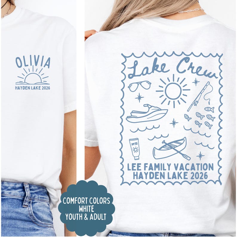 May include: White t-shirt with blue graphics. Front features the name "OLIVIA" above a sun and the text "HAYDEN LAKE 2026". Back has a "Lake Crew" design with vacation-themed illustrations and "LEE FAMILY VACATION HAYDEN LAKE 2026".