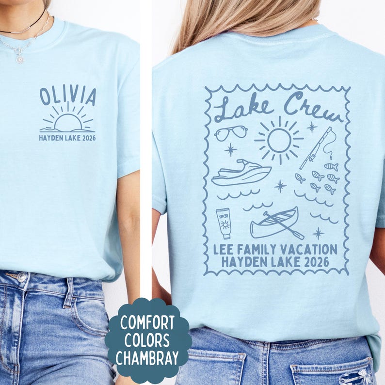 May include: Light blue t-shirts with custom graphics. One shirt features "Olivia" above a sun design and "Hayden Lake 2026." The other shirt has a "Lake Crew" design with lake-themed illustrations and "Lee Family Vacation Hayden Lake 2026."
