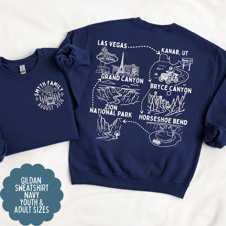 May include: Navy blue sweatshirts with white graphic designs. One features a family crest with text, the other a map with landmarks like the Grand Canyon and Las Vegas. The sweatshirts are available in youth and adult sizes.