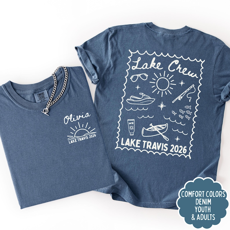May include: Two denim blue t-shirts. One has "Olivia" and "Lake Travis 2026" printed on the front. The other has a "Lake Crew" design with sunglasses, a sun, a jet ski, a fishing rod, fish, sunscreen, and a boat, with "Lake Travis 2026".