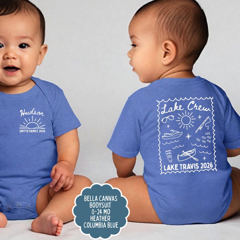 May include: Two babies wearing blue bodysuits. One bodysuit has the name "Hudson" and "SMYTH FAMILY 2026" printed on the front. The other has "Lake Crew" and "LAKE TRAVIS 2026" with lake-themed graphics on the back. The bodysuits are Columbia Blue.