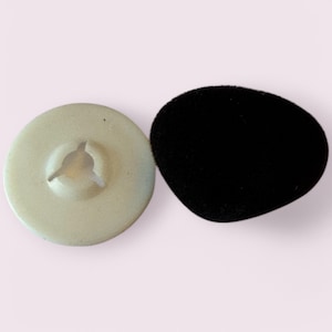 May include: A white plastic earbud with a black foam tip. The earbud has a small hole in the centre.
