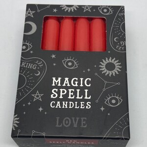 May include: A box of red magic spell candles for love. The box has a black background with silver stars, moons, and eyes. The text on the box reads "Magic Spell Candles Love".