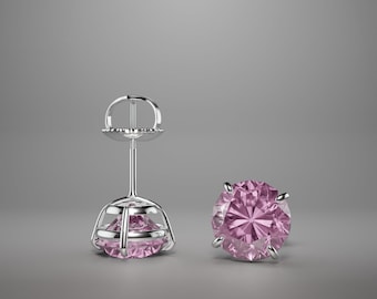 May include: A pair of silver stud earrings with a pink gemstone in each. The earrings have a simple design and are perfect for everyday wear.