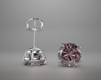 May include: A pair of silver stud earrings with a round, faceted, dark purple gemstone.