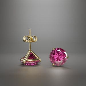 May include: A pair of gold stud earrings with a pink gemstone. The earrings have a simple design and are perfect for everyday wear.