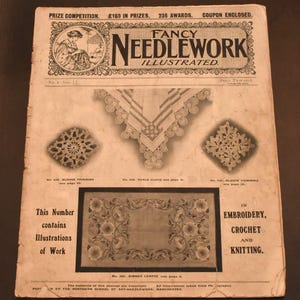 May include: A black and white magazine cover for Fancy Needlework Illustrated. The cover features a woman crocheting, a table cloth, and a dinner centre piece. The text on the cover reads "Fancy Needlework Illustrated" and "This Number contains Illustrations of Work in Embroidery, Crochet and Knitting."