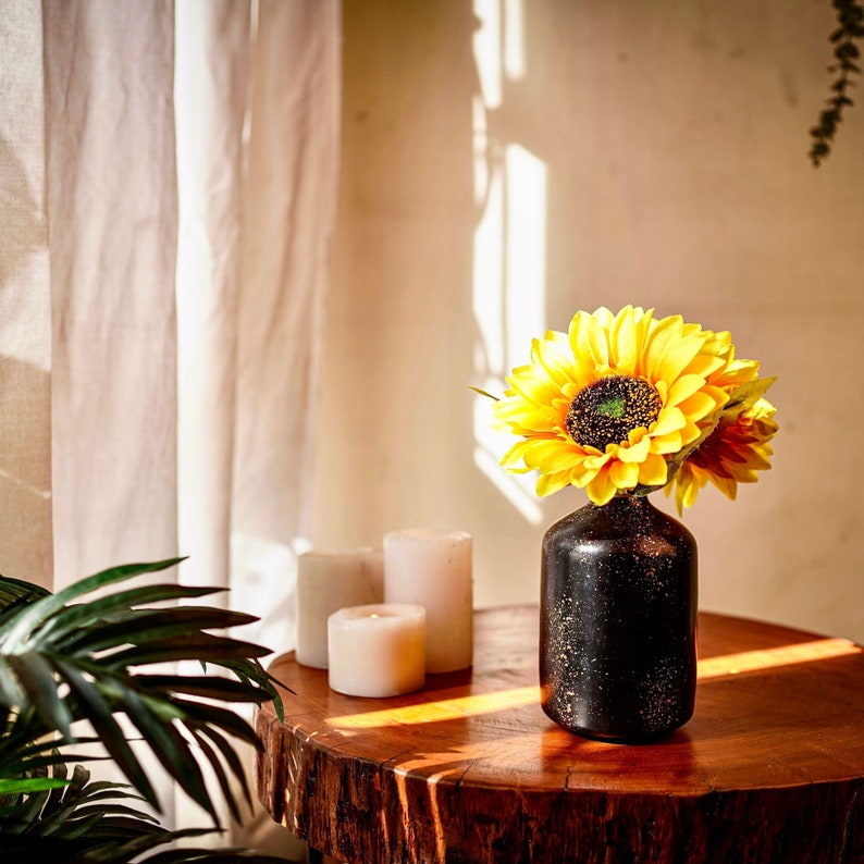 black spotted vase with sun flowers