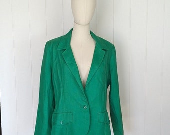 May include: A green blazer with a single button fastening and two pockets. The blazer has a notched collar and long sleeves.