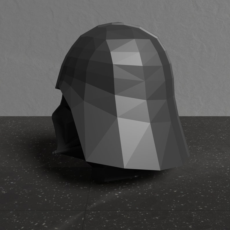 May include: A black, low-poly, 3D model of a Darth Vader helmet. The helmet is angled to the side, showing the left side of the helmet.
