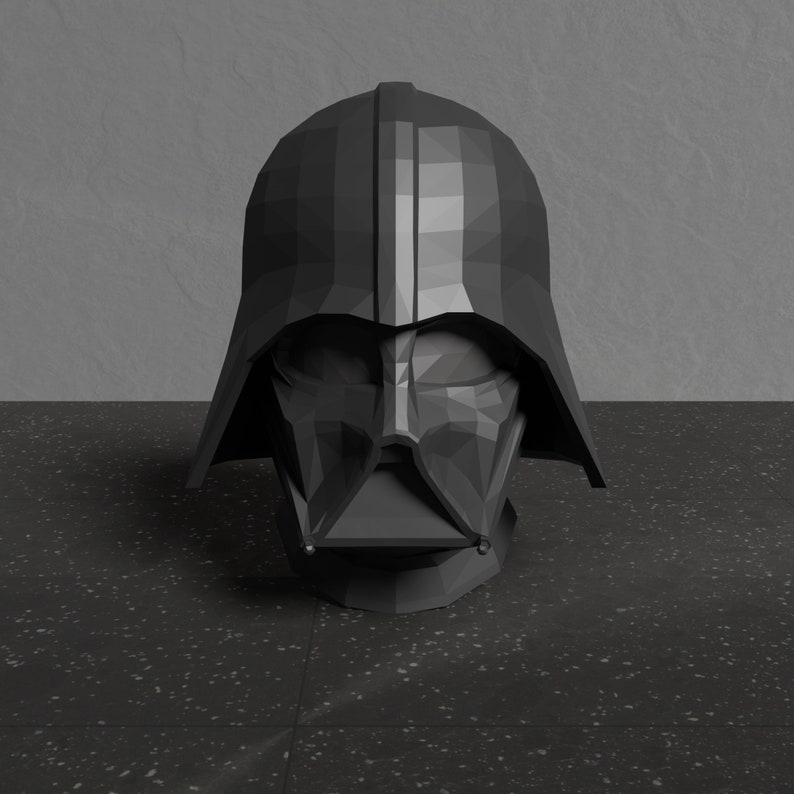 May include: A black, geometrically designed Darth Vader helmet. The helmet is made of a dark, matte material and has a sharp, angular design.