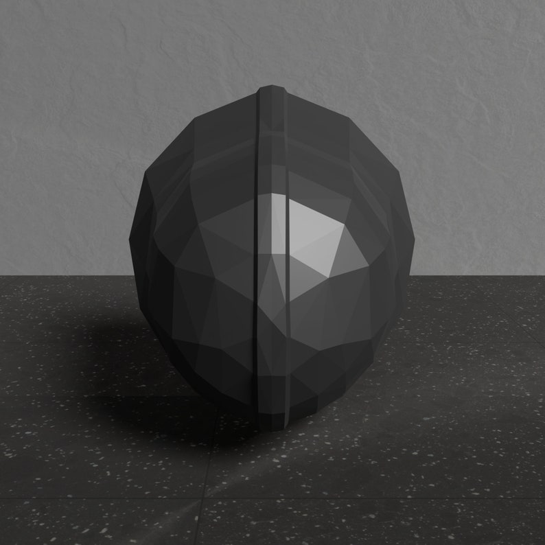 May include: A black, geometrically shaped sphere with a smooth, shiny surface. The sphere is made of a hard material and has a three-dimensional, faceted design.