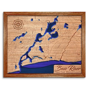 May include: A wooden framed map of Bass River in Cape Cod, Massachusetts. The map features a detailed laser-cut design with blue water features and a compass rose. The frame is a warm brown color.