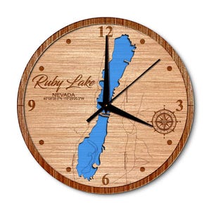 May include: A wooden clock with a map of Ruby Lake, Nevada. The lake is outlined in blue and the clock face has Roman numerals. The coordinates for Ruby Lake are printed below the lake name.