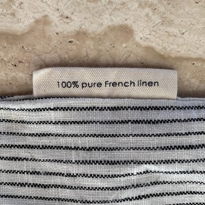 Closeup of the tag on Mellby Atelier linen sleep mask bag, explaining that it's made from 100 % pure French linen.