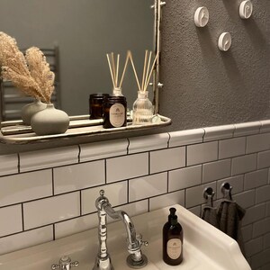 Vanilla sky scented candle in bathroom paired with a reed diffuser and hand soap