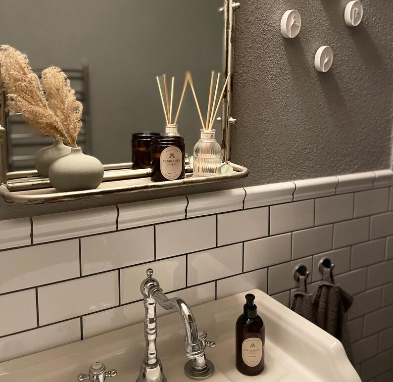 Vanilla sky scented candle in bathroom paired with a reed diffuser and hand soap