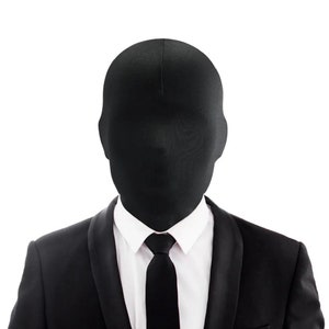 May include: A person wearing a black suit and a black mask covering their entire head. The person is wearing a white shirt and a black tie.