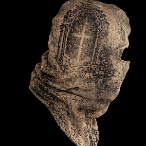 May include: A beige and black textured balaclava featuring a printed graphic of an arched doorway with a cross inside. The fabric has a weathered, stone-like appearance with a single eye opening on the right side and a folded neck section.