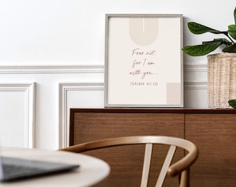 May include: A framed print with the text "Fear not: for I am with you..." from Isaiah 41:10. The artwork features a beige background with a minimalist design in brown. The print is displayed on a wooden cabinet with a woven basket and plant.