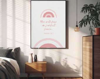May include: A rectangular wall art print featuring a white background with two pink semi-circular rainbow designs at the top and bottom. The center text reads, You will keep in perfect peace... ISAIAH 26:3, written in a pink cursive script font.