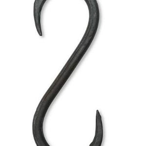 May include: A black metal S-shaped hook. The hook is made of forged iron and has a rustic, industrial look.