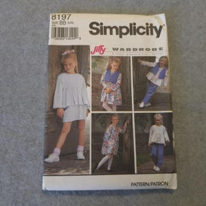 May include: A Simplicity Jiffy Wardrobe sewing pattern envelope, number 8197, size BB (5-6X). The front features photographs of clothing including a light blue dress, a floral dress with a blue vest, and a long-sleeved top with blue pants.