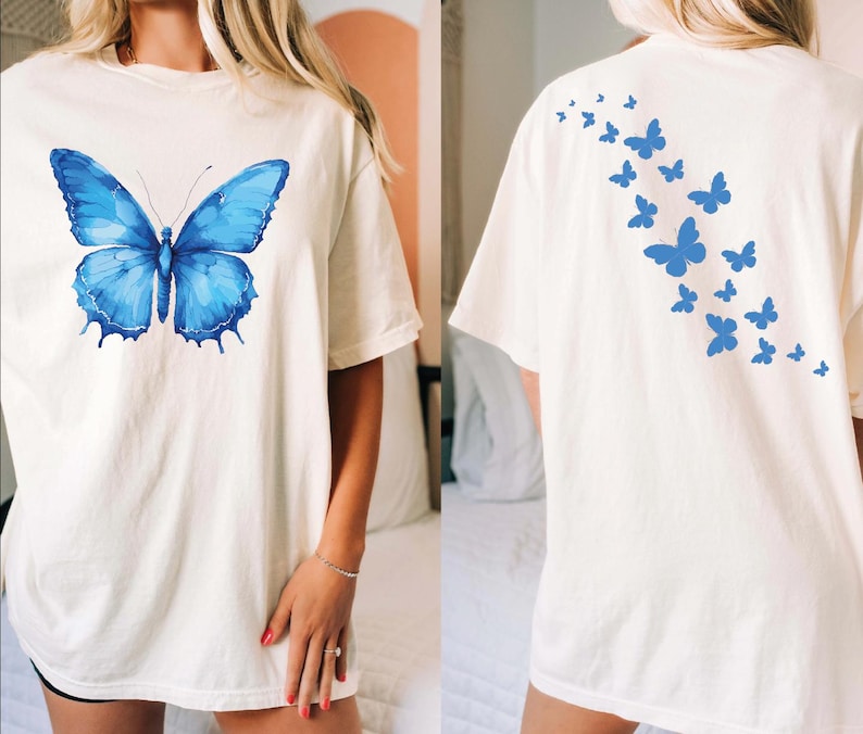 a woman wearing a white shirt with a blue butterfly on it