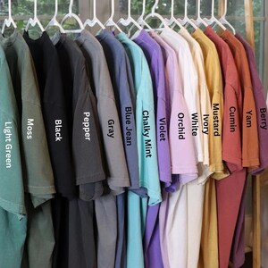a rack of shirts with the names of different colors