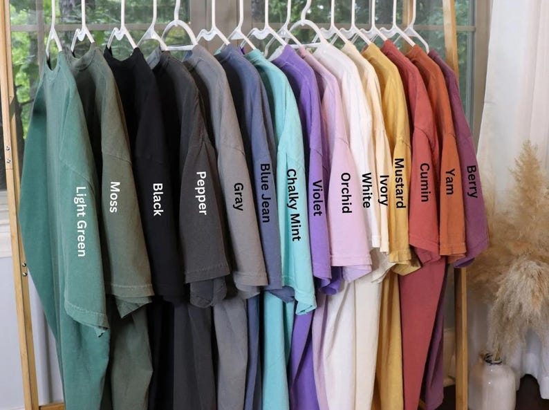 a rack of shirts with the names of different colors