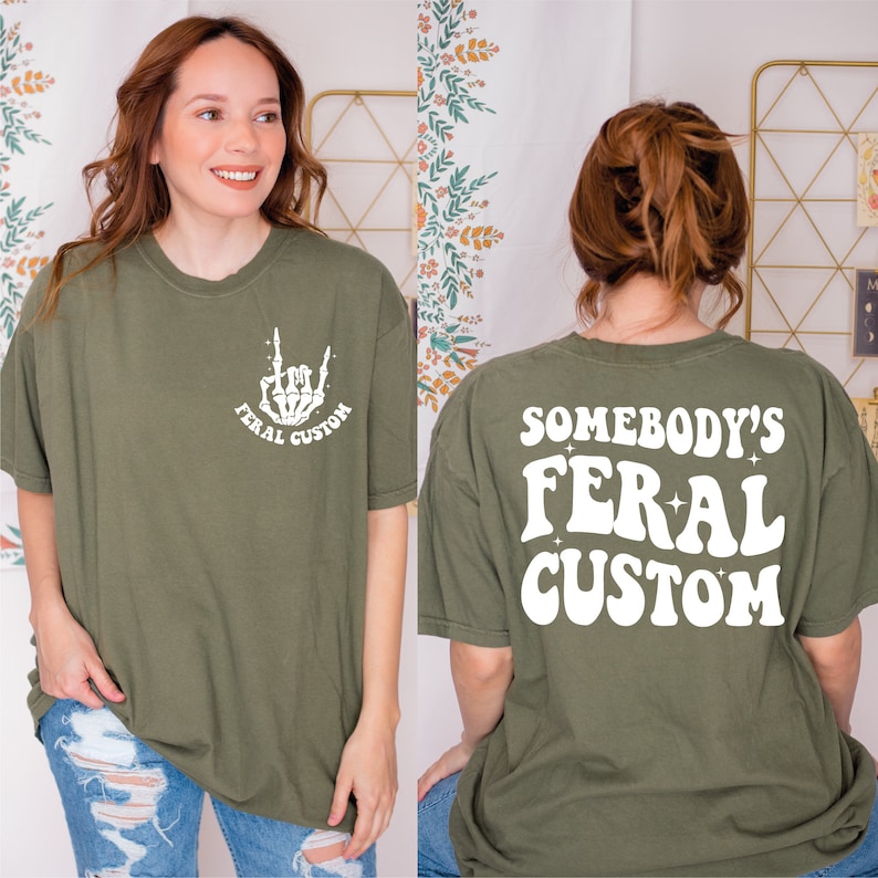 a woman wearing a t - shirt that says somebody's feral custom