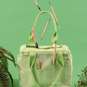 lime green pottery tool bag with tools in front pockets