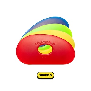 May include: A stack of colorful pottery rib tools in red, yellow, green, and blue. The red tool is in the front, with the text "MUDTOOLS" and a hole in the center. The text "SHAPE O" is in a yellow box below.