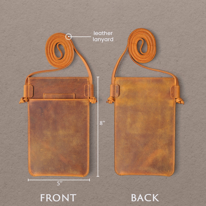 May include: A brown leather phone pouch with a front pocket and an adjustable leather strap. The pouch measures 5 inches wide and 8 inches tall.