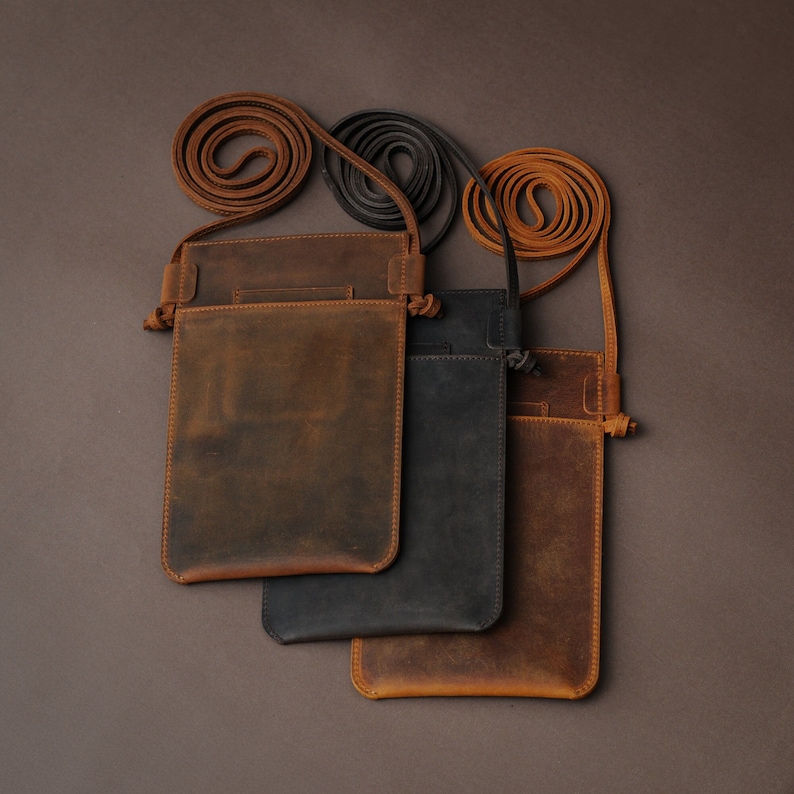 May include: Three leather phone pouches with adjustable straps. The pouches are brown, black, and a lighter brown color.