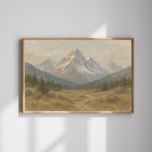 May include: A framed landscape painting depicts a mountain range with snow-capped peaks. The artwork features a winding path through a valley with trees and grassy areas. The color palette includes muted greens, browns, and blues.