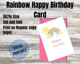 May include: Printable 5x7 inch happy birthday card featuring a rainbow, sun, and clouds. The card is digital and can be printed on regular copy paper.