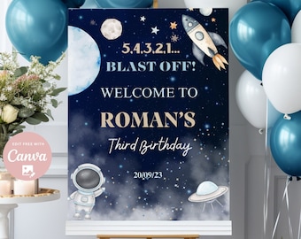 May include: A blue and white birthday sign with a rocket, stars, and a moon. The sign says "5.4.3.2.1... BLAST OFF! WELCOME TO ROMAN'S Third Birthday 20/09/23".