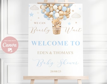 Könnte beinhalten: Ein Willkommens-Schild für eine Babyparty mit einem Teddybären in einem Heißluftballon aus blauen und goldenen Ballons. Das Schild lautet "We can Bearly Wait" und "Welcome to Eden & Thomas's Baby Shower 20/08/23".