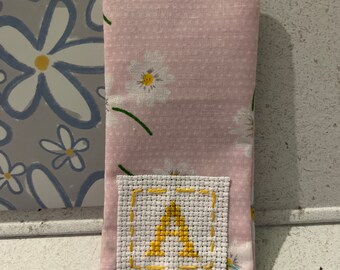 Homemade fabric bookmark with cross stitched initial