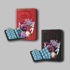 May include: Two card binders, one red and one black, each featuring a large letter "R" and a colorful graphic of cartoon characters. The binders are open, revealing rows of card slots.