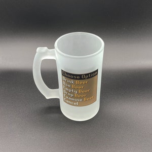 May include: A frosted glass beer mug with a black and gold design. The mug has a handle and says "Choose Option" with a list of options: "Drink Beer", "Use Beer", "Empty Beer", "Drop Beer", "Examine Beer", "Cancel".