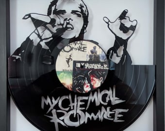 May include: A black vinyl record art piece framed in a square black frame. The record is laser-cut into the silhouette of a singer holding a microphone. The center label features the text My Chemical Romance and various graphic illustrations.